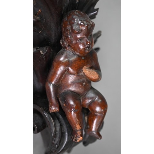 1017 - An antique (probably 17th century) carved wood putto, on scrolling foliate bracket (possibly later),... 