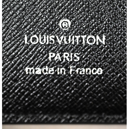 1023 - Louis Vuitton - A gent's black and grey folding wallet, with protective pouch and cardboard box