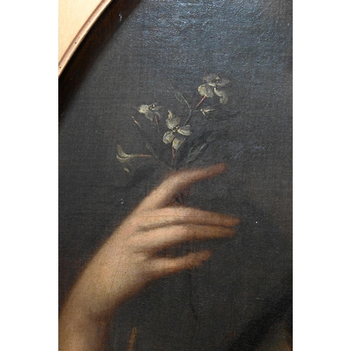 704 - An 18th century portrait of a young lady holding a white flower, oil on canvas, 79 x 66 cm frame a/f... 