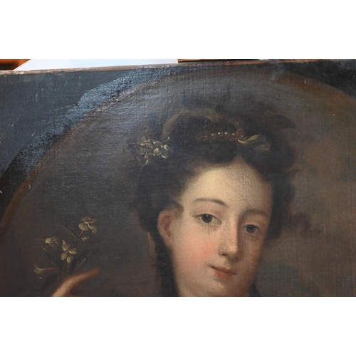 704 - An 18th century portrait of a young lady holding a white flower, oil on canvas, 79 x 66 cm frame a/f... 