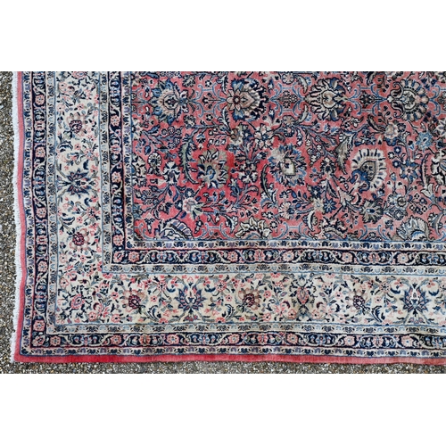 729 - A large Indo Persian Sarouk carpet, the lozenge pole design on pale salmon ground, 400 cm x 361 cm
