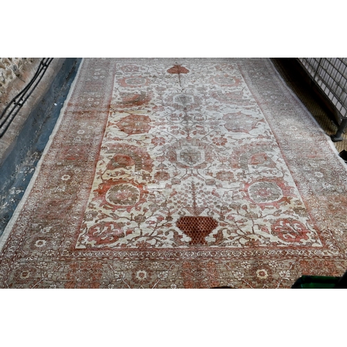 733 - An Indian Agra carpet, mid 20th century, the traditional geometric design on muted ground, 360 cm x ... 