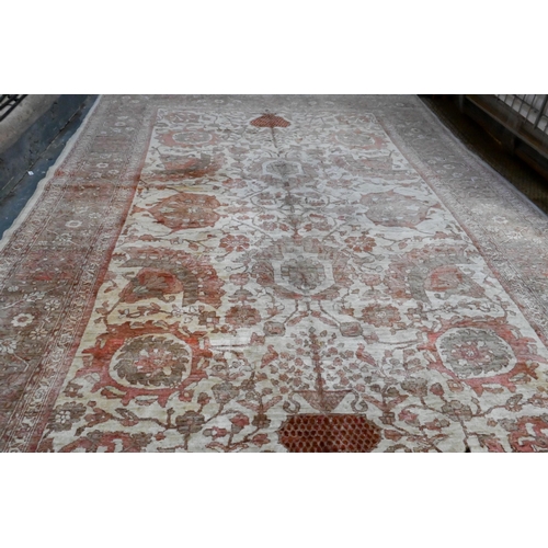 733 - An Indian Agra carpet, mid 20th century, the traditional geometric design on muted ground, 360 cm x ... 