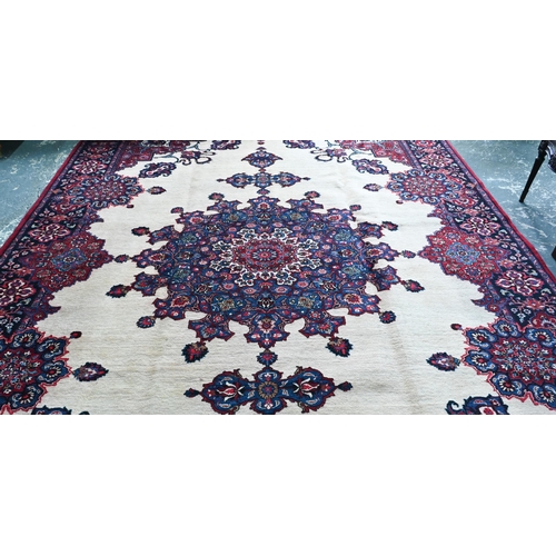 734 - A North East Persian Meshed carpet, the camel ground centred with a blue medallion, 440 cm x 300 cm