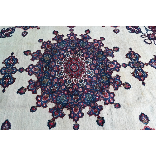 734 - A North East Persian Meshed carpet, the camel ground centred with a blue medallion, 440 cm x 300 cm