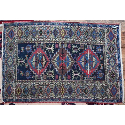 737 - An old Caucasian navy blue ground rug, 184 cm x 125 cm