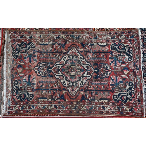 738 - An old Persian Hamadan rug, the red ground centred by a floral medallion, 204 cm x 125 cm