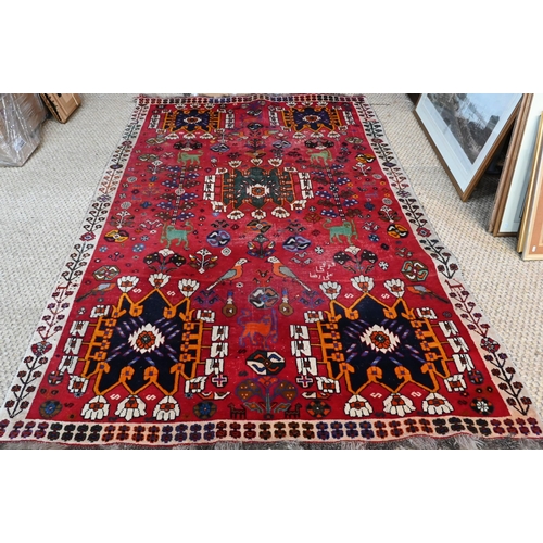 744 - A contemporary Persian Gabbeh rug, the red ground with stylises birds, beast and flowering vines, 26... 