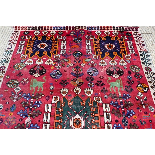 744 - A contemporary Persian Gabbeh rug, the red ground with stylises birds, beast and flowering vines, 26... 