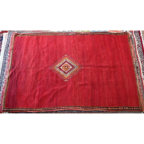 745 - A small contemporary Moroccan style carpet, the overall mottled red ground centred by a contrasting ... 
