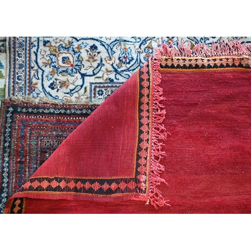 745 - A small contemporary Moroccan style carpet, the overall mottled red ground centred by a contrasting ... 