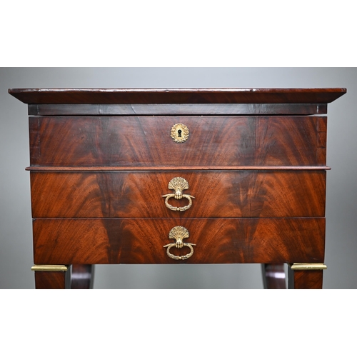 808 - A French Empire gilt metal mounted figured mahogany work table, 19th century, the hinged top enclosi... 