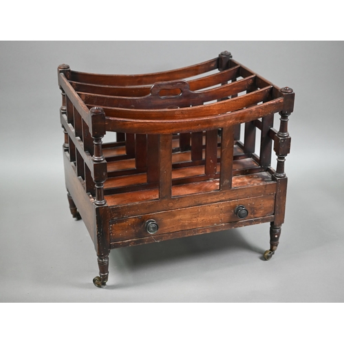 813 - A Victorian mahogany four division canterbury with drawer to base, raised on turned legs to brass ca... 