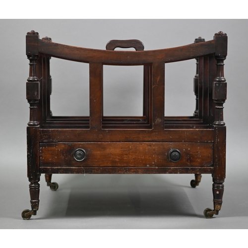 813 - A Victorian mahogany four division canterbury with drawer to base, raised on turned legs to brass ca... 