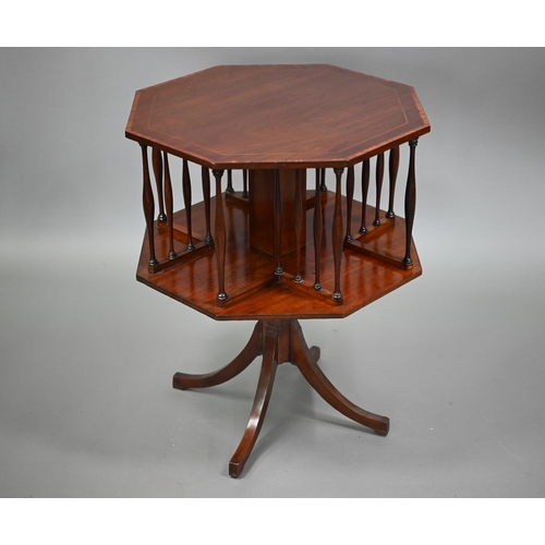 816 - An octagonal cross-banded red walnut low revolving bookcase, mid 20th century, raised on a centre pi... 