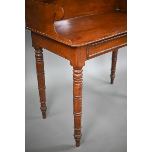 823 - A Victorian mahogany stand, the top with 3/4 gallery over a bead moulded frieze and raised on ring-t... 