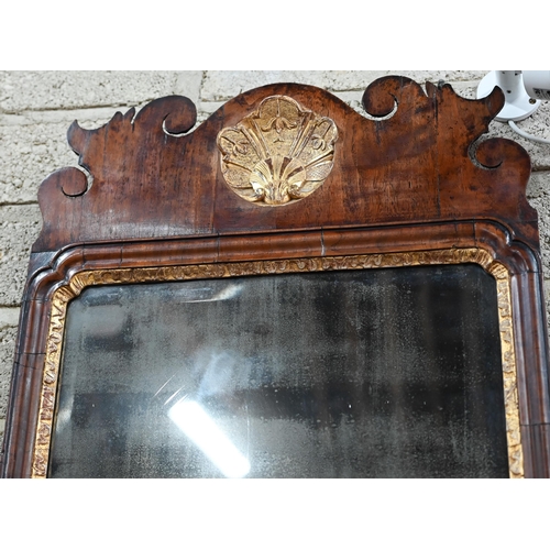 830 - A George II walnut and parcel gilt fret cut pier glass, the original distressed bevel edge plate wit... 