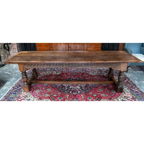 833 - A 17th century and later composed oak refectory table, the wide two plank top with cleated ends rais... 