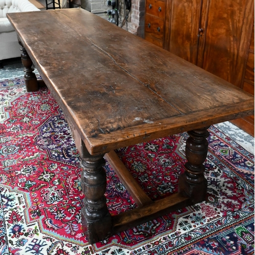 833 - A 17th century and later composed oak refectory table, the wide two plank top with cleated ends rais... 