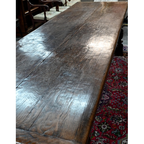 833 - A 17th century and later composed oak refectory table, the wide two plank top with cleated ends rais... 