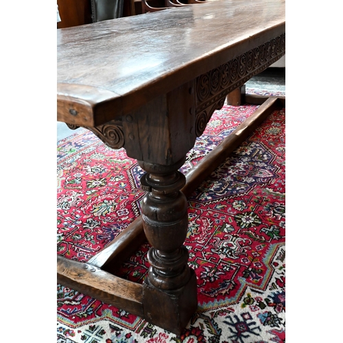 833 - A 17th century and later composed oak refectory table, the wide two plank top with cleated ends rais... 