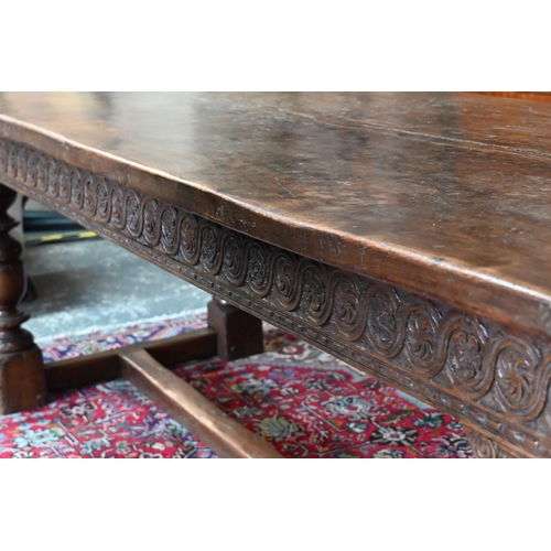 833 - A 17th century and later composed oak refectory table, the wide two plank top with cleated ends rais... 