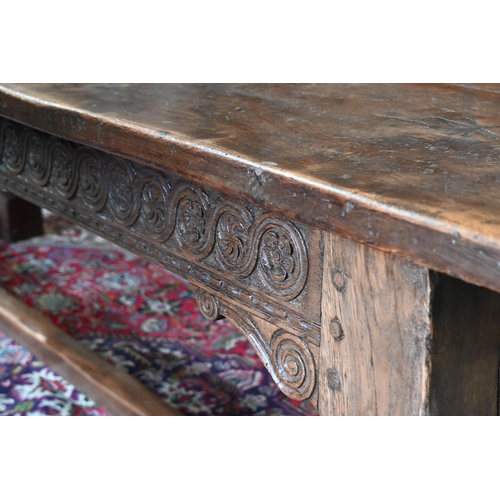 833 - A 17th century and later composed oak refectory table, the wide two plank top with cleated ends rais... 