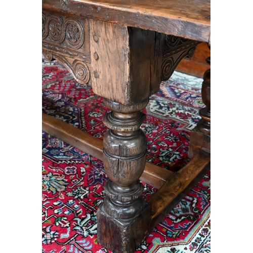 833 - A 17th century and later composed oak refectory table, the wide two plank top with cleated ends rais... 