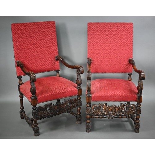 836 - A pair of 17th century style carved walnut throne armchairs, with studded rouge fleur-de-lys pattere... 