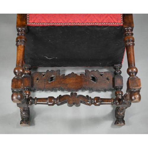 836 - A pair of 17th century style carved walnut throne armchairs, with studded rouge fleur-de-lys pattere... 