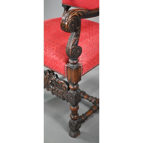 836 - A pair of 17th century style carved walnut throne armchairs, with studded rouge fleur-de-lys pattere... 