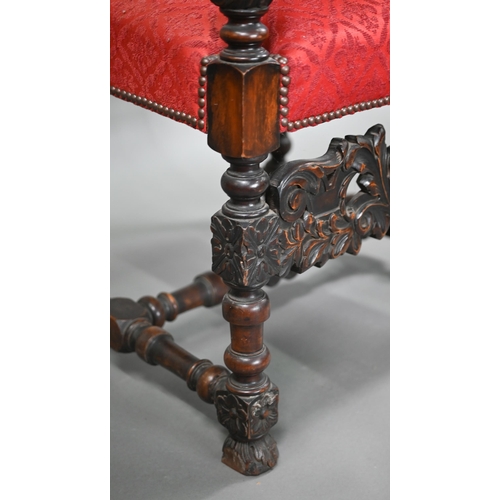 836 - A pair of 17th century style carved walnut throne armchairs, with studded rouge fleur-de-lys pattere... 