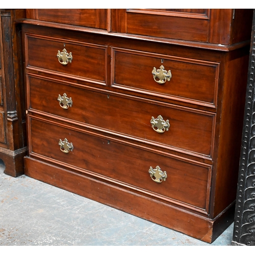 838 - A late 19th century mahogany linen press, the moulded shaped cornice over a pair of arched panel doo... 