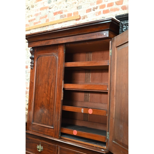838 - A late 19th century mahogany linen press, the moulded shaped cornice over a pair of arched panel doo... 
