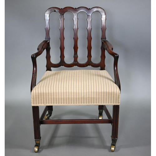 839 - A George III mahogany elbow chair, the vertical four bar back over shaped arms and an overstuffed sa... 