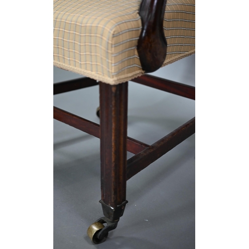 839 - A George III mahogany elbow chair, the vertical four bar back over shaped arms and an overstuffed sa... 