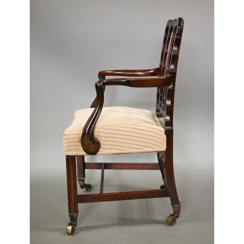 839 - A George III mahogany elbow chair, the vertical four bar back over shaped arms and an overstuffed sa... 