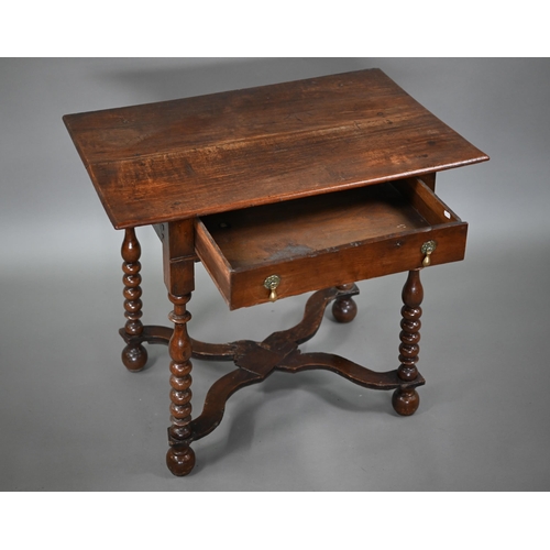 845 - An early 18th century oak single drawer side table, raised on part bobbin turned supports united by ... 