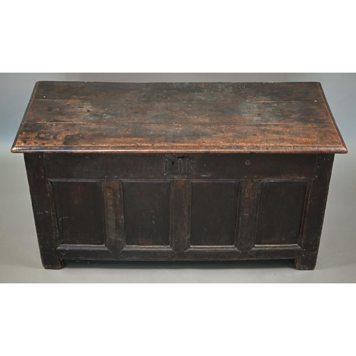 857 - An early 18th century joint oak coffer, the triple plank top over a four panel front an raised on st... 