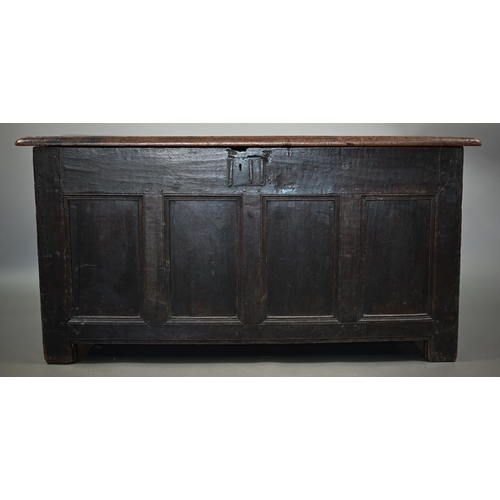 857 - An early 18th century joint oak coffer, the triple plank top over a four panel front an raised on st... 