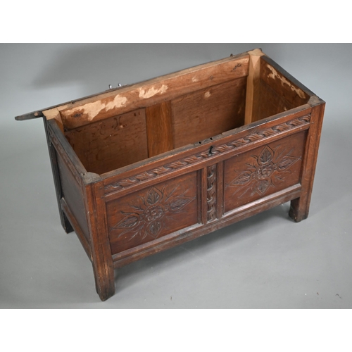 858 - A late 17th century carved joint oak coffer, the staple hinged top over two floral carved panels, on... 