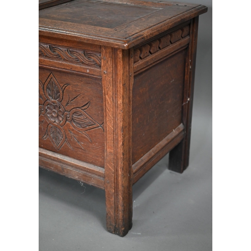 858 - A late 17th century carved joint oak coffer, the staple hinged top over two floral carved panels, on... 