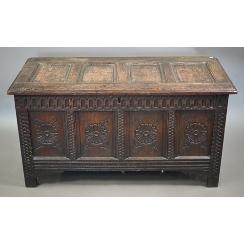 859 - A late 17th century joint oak coffer, the four panel top over a carved and moulded four panel front,... 