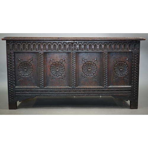 859 - A late 17th century joint oak coffer, the four panel top over a carved and moulded four panel front,... 