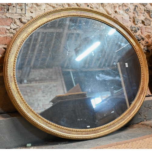 862 - A large Victorian oval giltwood framed mirror, 145 cm x 112 cm