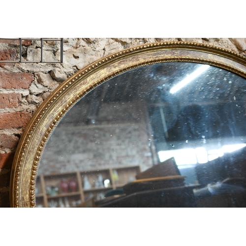 862 - A large Victorian oval giltwood framed mirror, 145 cm x 112 cm