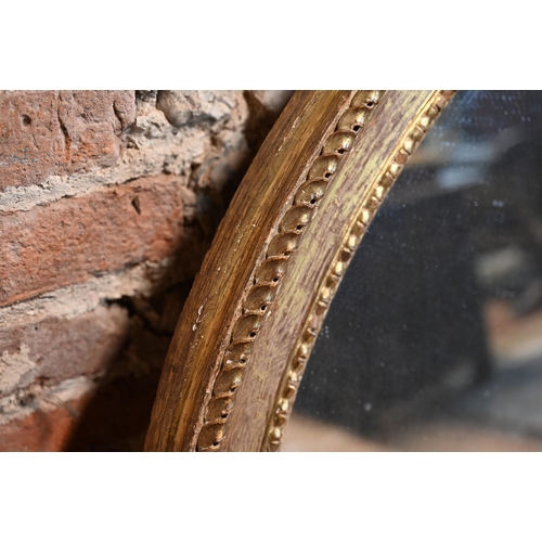 862 - A large Victorian oval giltwood framed mirror, 145 cm x 112 cm