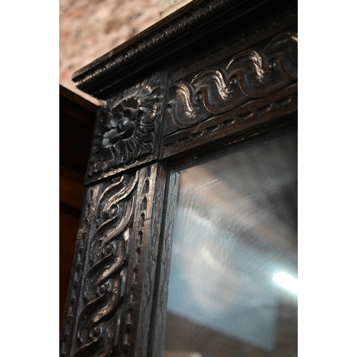 864 - A large 17th century style carved oak framed tall mirror, circa 1900, size cm x cm h