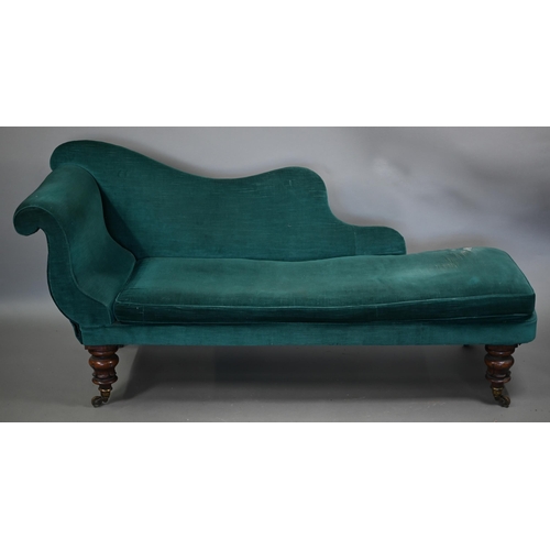 866 - A Victorian rosewood framed scroll end chaise lounge, in teal fabric with seat cushion and raised on... 