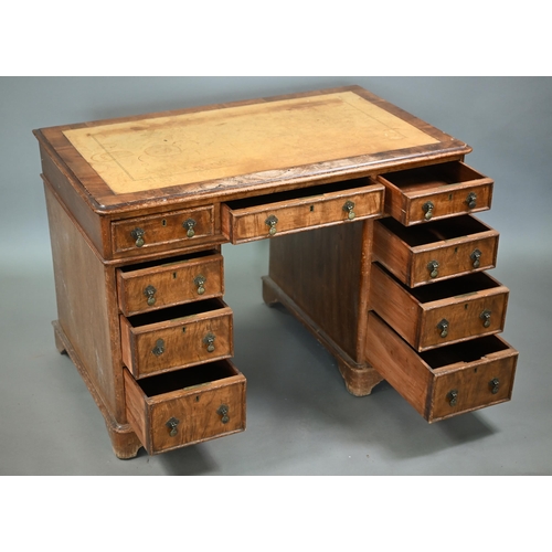 874 - A Victorian walnut twin pedestal desk, the inset tan leather top over an arrangement of moulded edge... 